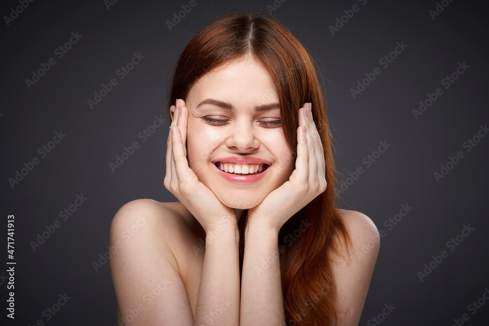 pretty red-haired woman naked shoulders posing dark background pretty red-haired woman naked shoulders posing dark background
