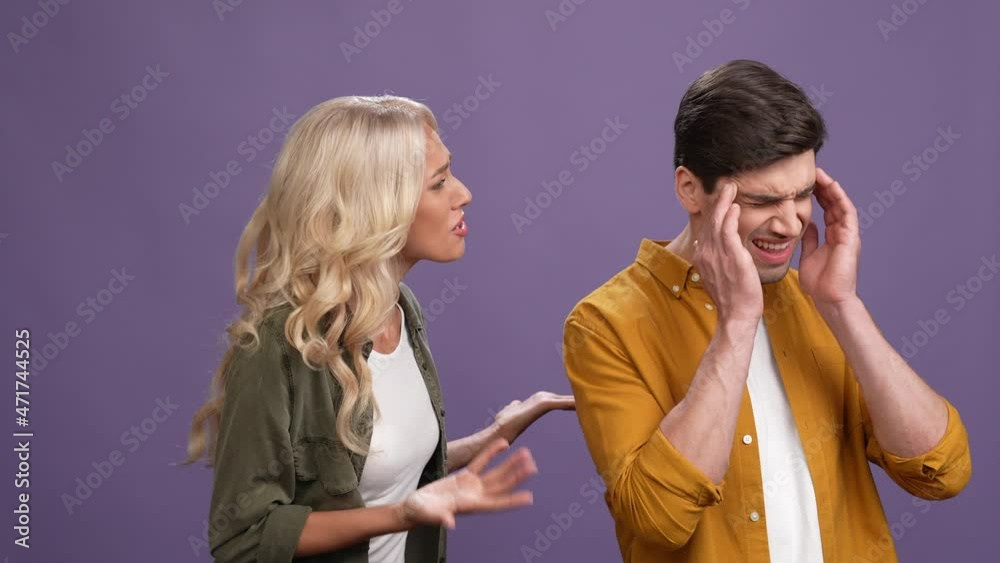 Lady lose temper angry scream guy head ache isolated purple color background Lady lose temper angry scream guy head ache isolated purple color background