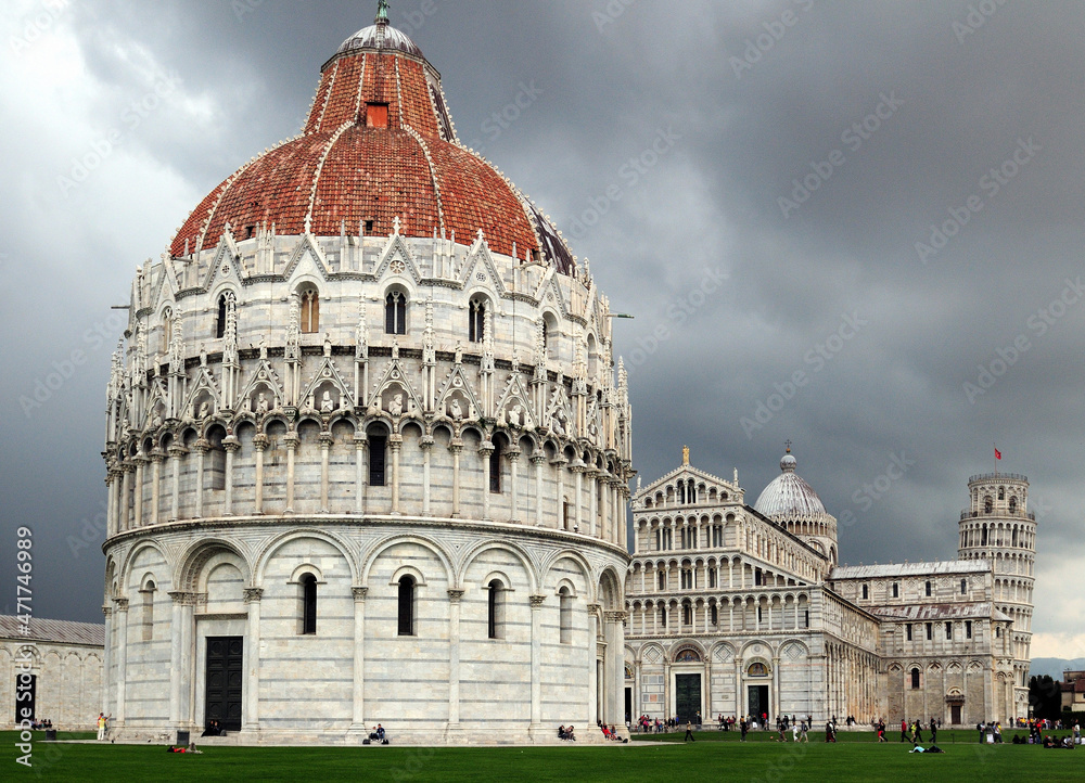 Baptistery At Piazza Dei Miracoli In Pisa On A Beautiful Spring Day With Dark Clouds In The Sky
