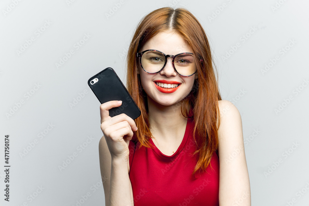 emotional red-haired woman with a phone in her hands communicating gadget emotional red-haired woman with a phone in her hands communicating gadget