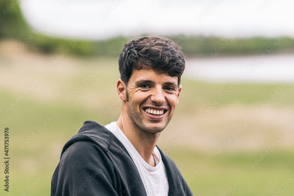 Smiling caucasian man with sports clothes in a park Smiling caucasian man with sports clothes in a park
