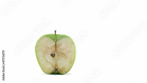Green and half apple getting rot on a white background timelapse footage