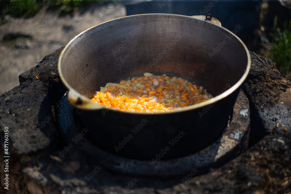 Large cauldron with a fluffy soup on the street Large cauldron with a fluffy soup on the street