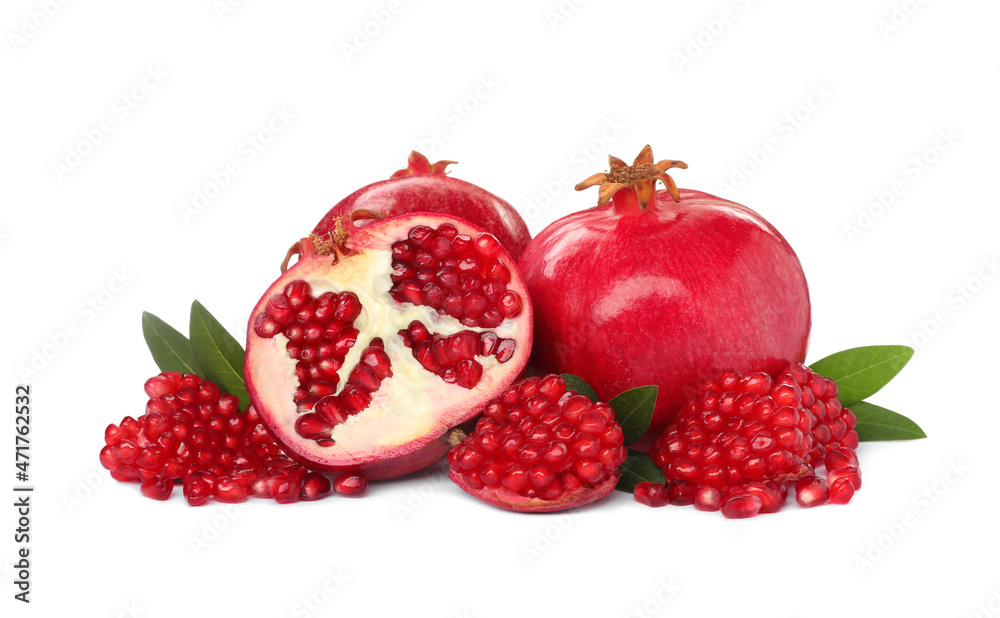 Tasty ripe pomegranates and leaves on white background Tasty ripe pomegranates and leaves on white background