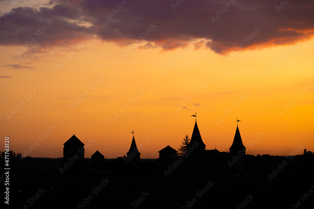 Silhouette of an old medieval castle during sunset