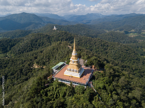 Aerial view of the large pagoda in Wat Phrathat Mon Phrachao Lai located on mountain elevation above seal level is 618 metres in Chiang Rai province, Thailand.