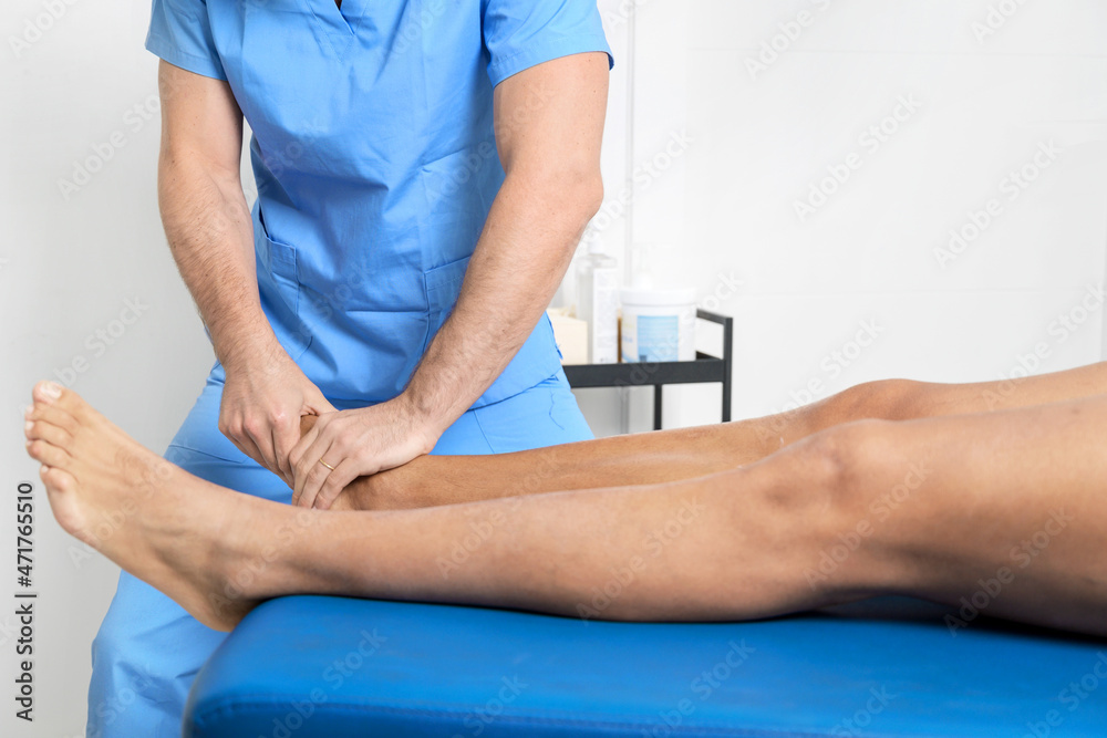 Close-up of therapist massaging young man's foot. High quality photo.