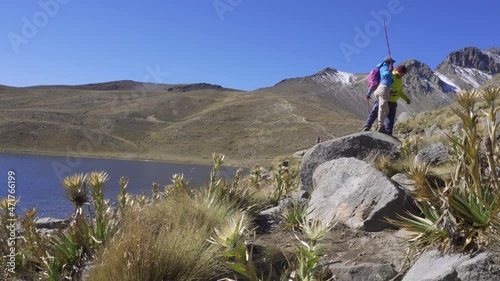 Couple Trekking on the natural landscape. Hiking man and woman photo