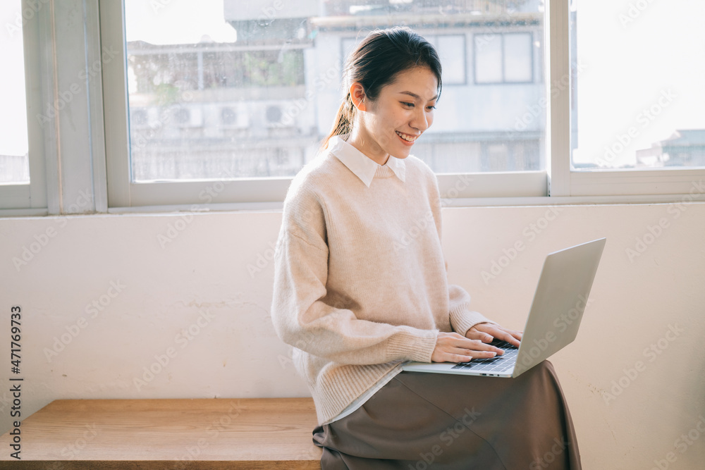 Young Asian businesswoman using laptop at home Young Asian businesswoman using laptop at home