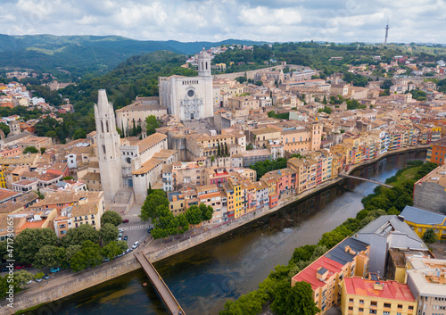 Aerial view of main landmarks of Girona - Saint Mary Cathedral and Collegiate Church of Sant Feliu on Onyar river, Spain