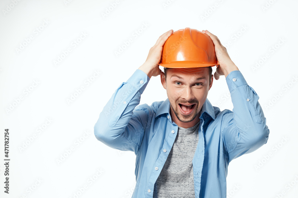 male builder orange helmet engineer safety light background