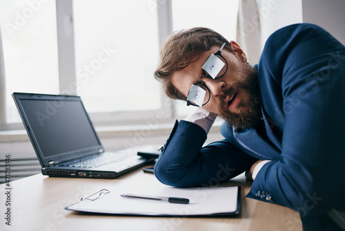 businessmen sitting at a desk in front of a laptop finance network official