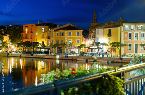 Picturesque evening view of coastal town of Martigues divided by canals with colorful residential buildings along waterfronts in summer, France