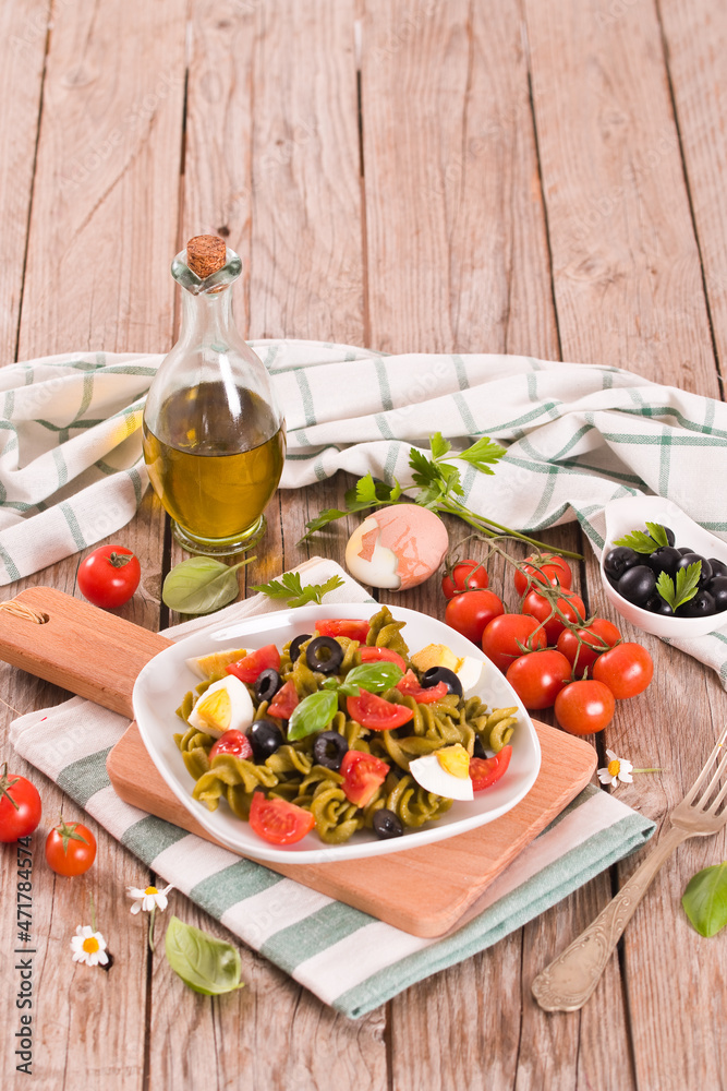 Fusilli pasta with cherry tomatoes, eggs and black olives. Fusilli pasta with cherry tomatoes, eggs and black olives.