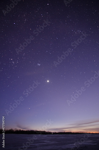 View of the starry sky over the Irtysh river covered with ice © alekskai