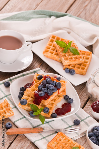 Waffles with blueberries and jam. 