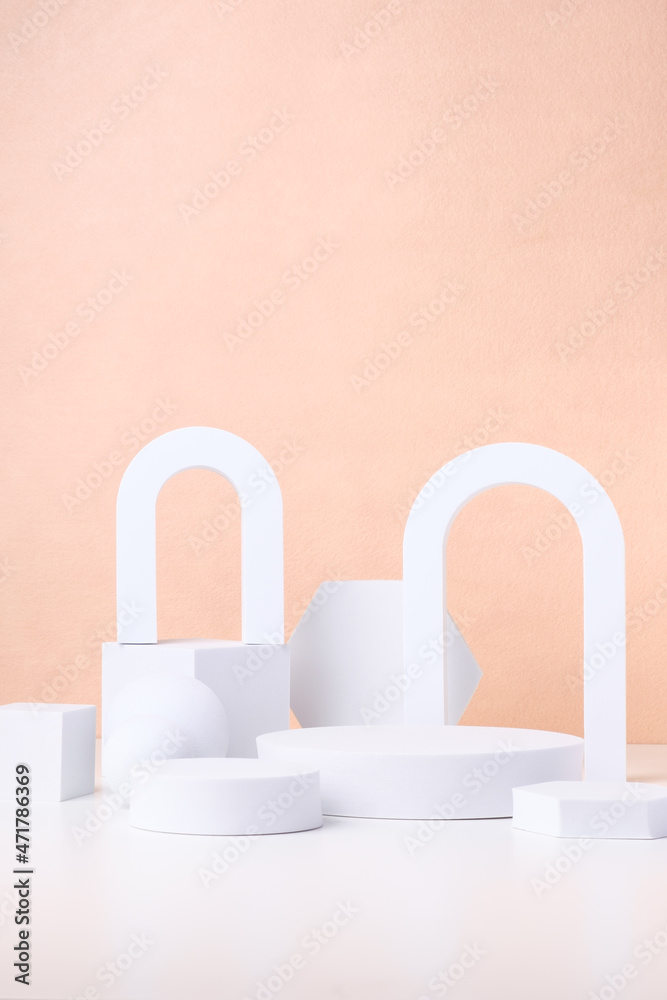 Geometric pedestal block on white table and pastel peach background.mockup for display product