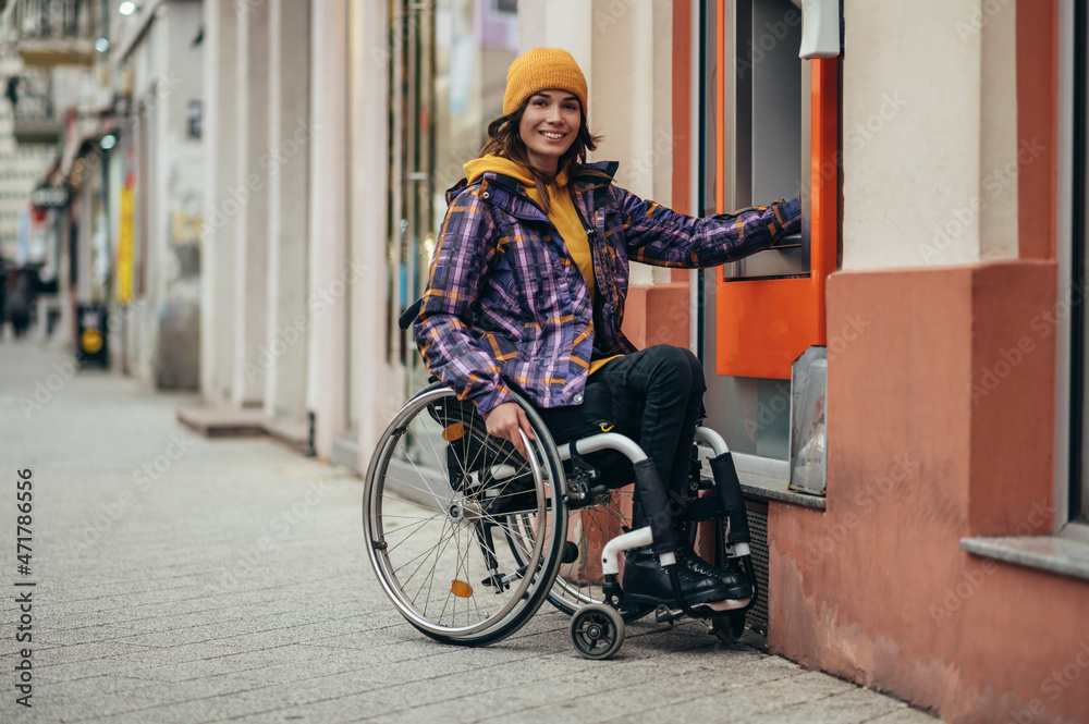 Woman with disability using credit card and atm machine Woman with disability using credit card and atm machine
