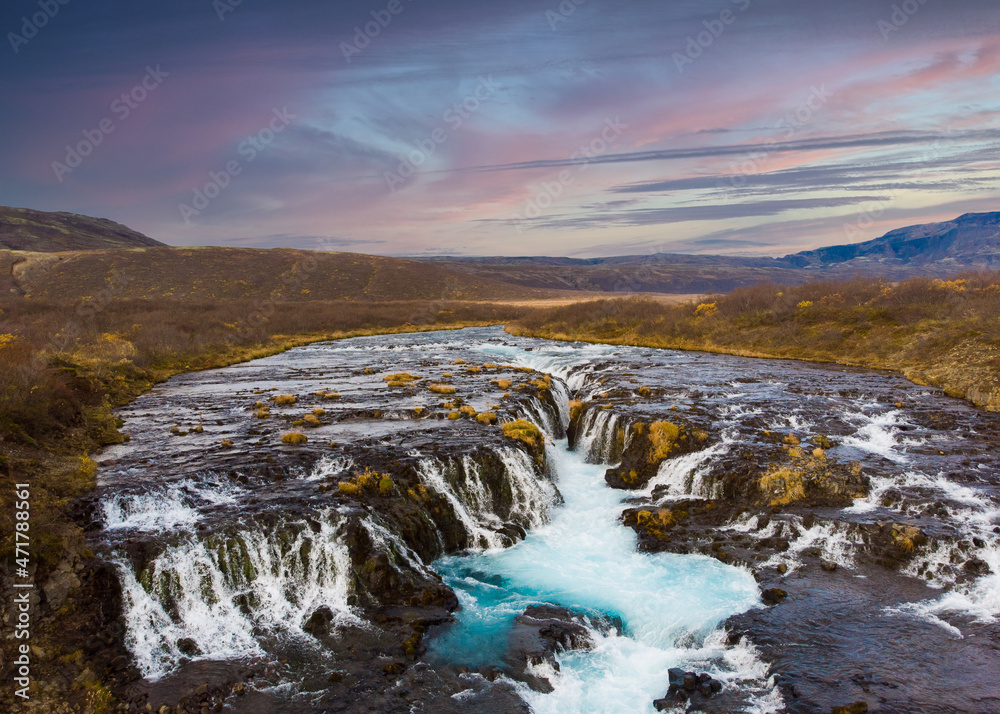 Fototapeta premium Colorful sunset at the Bruarfoss waterfall in south Iceland with blue water