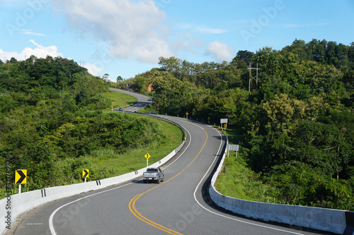 The asphalt road curves like number three on mountain. Curved Road No.3 or Route No.1081 over top of mountains in Santisuk - Bo Kluea District, Nan province, Thailand. Popular places for tourists.