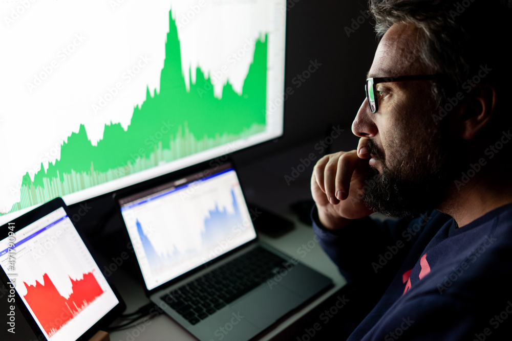 Crypto trader investor analyst looking at screen analyzing financial graph data on pc monitor, online stock exchange market ,over shoulder view. Crypto trader investor analyst looking at screen analyzing financial graph data on pc monitor, online stock exchange market ,over shoulder view.