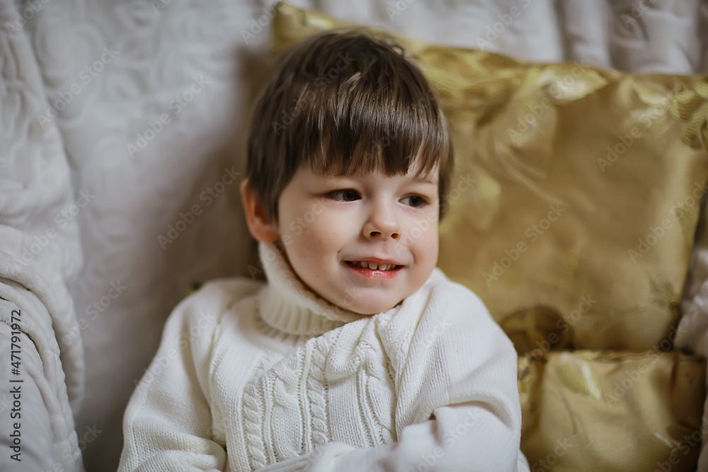 boy sitting on an armchair new year interior studio boy sitting on an armchair new year interior studio
