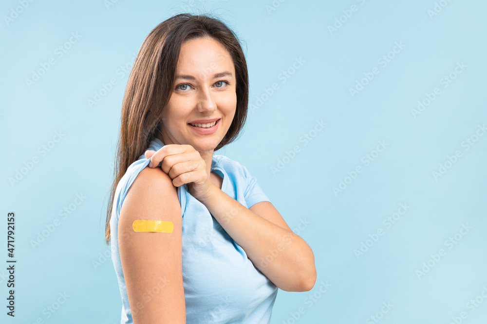 Smiling young woman after vaccination against coronavirus - obrazy, fototapety, plakaty 