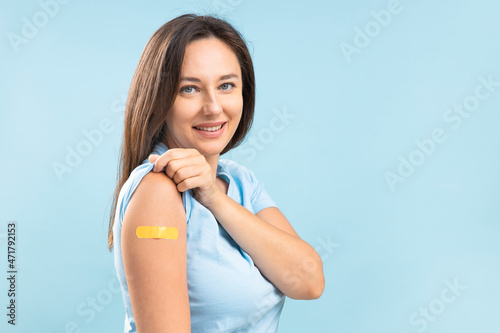 Smiling young woman after vaccination against coronavirus photo