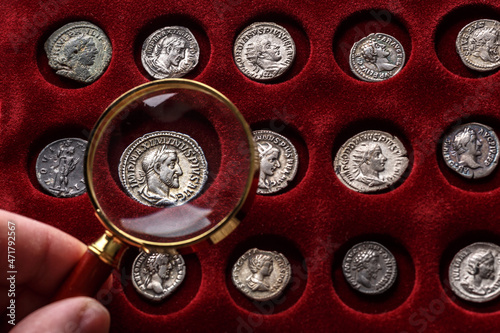 Numismatics.Authentic silver denarius, antoninianus of ancient Rome. A collector holds an old coin.Ancient coin of the Roman Empire photo