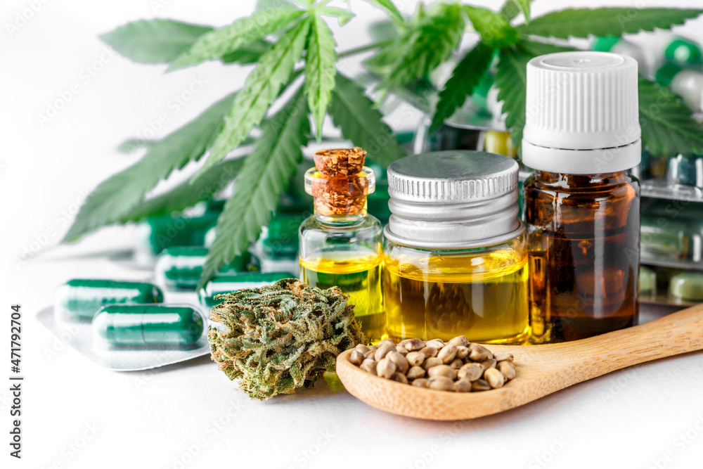 Green leaves of medicinal cannabis with extract oil.Medical marijuana flower buds. Hemp buds - medical marijuana concept.isolated on white Green leaves of medicinal cannabis with extract oil.Medical marijuana flower buds. Hemp buds - medical marijuana concept.isolated on white