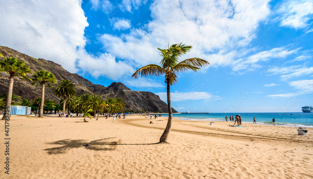 Inviting golden Playa de Las Teresitas beach with palm tree against blue sky, Tenerife, Canary Islands Inviting golden Playa de Las Teresitas beach with palm tree against blue sky, Tenerife, Canary Islands