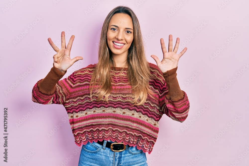 Beautiful hispanic woman wearing hippie sweater showing and pointing up with fingers number nine while smiling confident and happy. Beautiful hispanic woman wearing hippie sweater showing and pointing up with fingers number nine while smiling confident and happy.