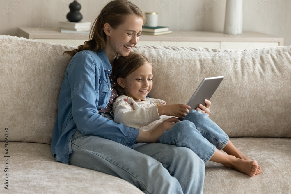 Addicted to modern technology smiling bonding multigenerational female family using touchpad gadget educational applications, playing games online, watching funny video, shopping in internet store. Addicted to modern technology smiling bonding multigenerational female family using touchpad gadget educational applications, playing games online, watching funny video, shopping in internet store.