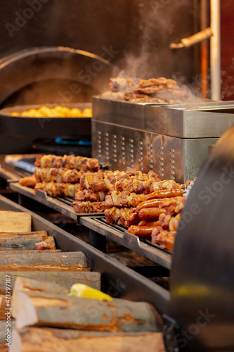Traditional Christmas fair food, sausages and meat on charcoal at old town city square in Wroclaw, Poland