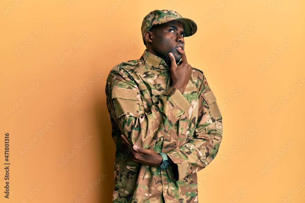 Young african american man wearing army uniform thinking worried about a question, concerned and nervous with hand on chin Young african american man wearing army uniform thinking worried about a question, concerned and nervous with hand on chin