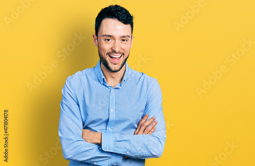 Hispanic man with beard with arms crossed gesture smiling and laughing hard out loud because funny crazy joke.
