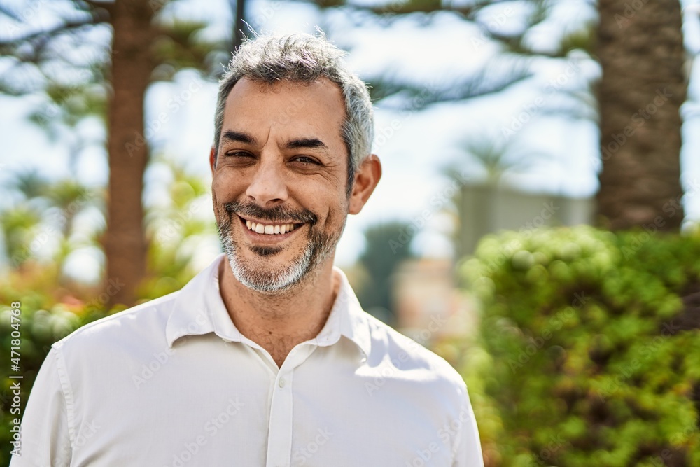 Middle age grey-haired man smiling happy standing at the city. Middle age grey-haired man smiling happy standing at the city.