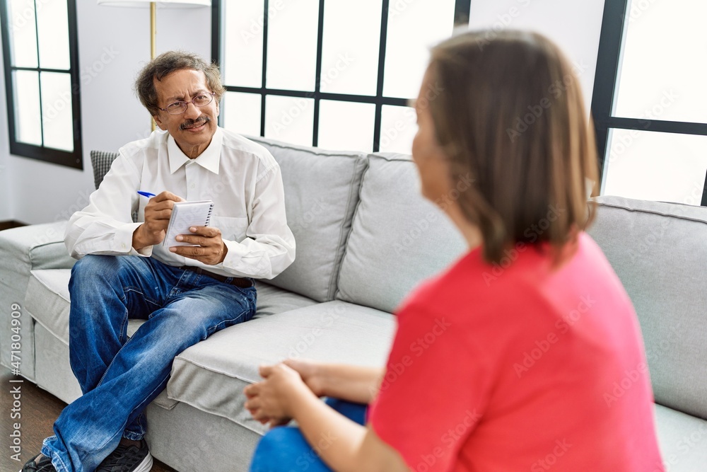 Middle age man and woman having psychology session at home Middle age man and woman having psychology session at home