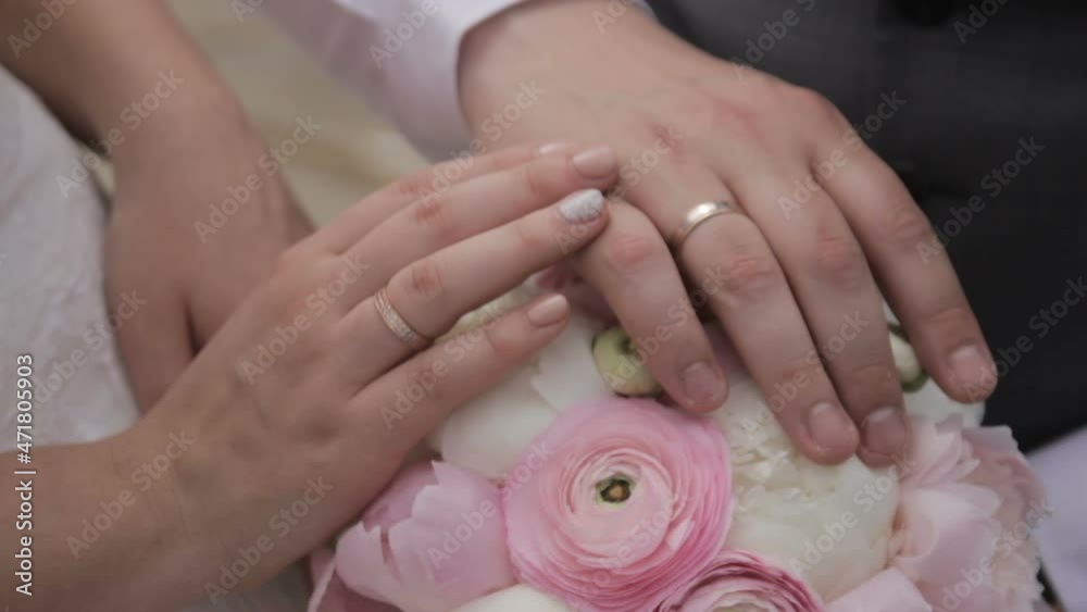Hands and rings on wedding bouquet Hands and rings on wedding bouquet
