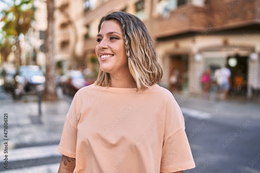 Fototapeta premium Young hispanic woman smiling confident at street