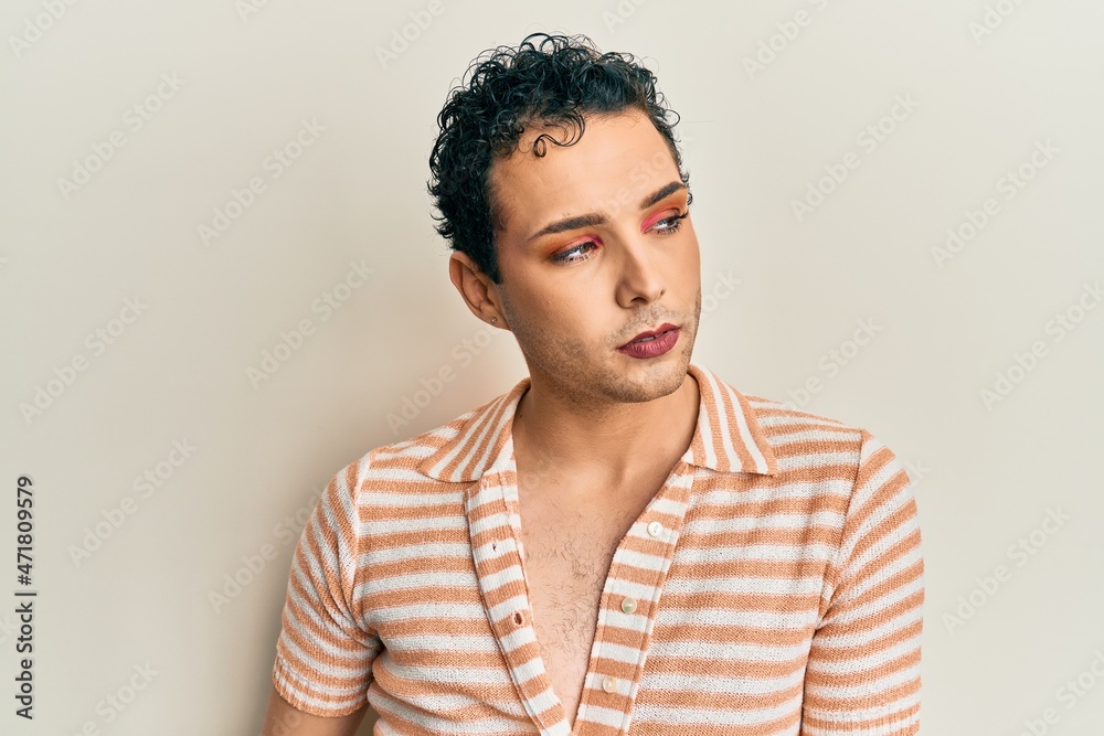Fototapeta premium Handsome man wearing make up wearing casual shirt smiling happy and positive, thumb up doing excellent and approval sign
