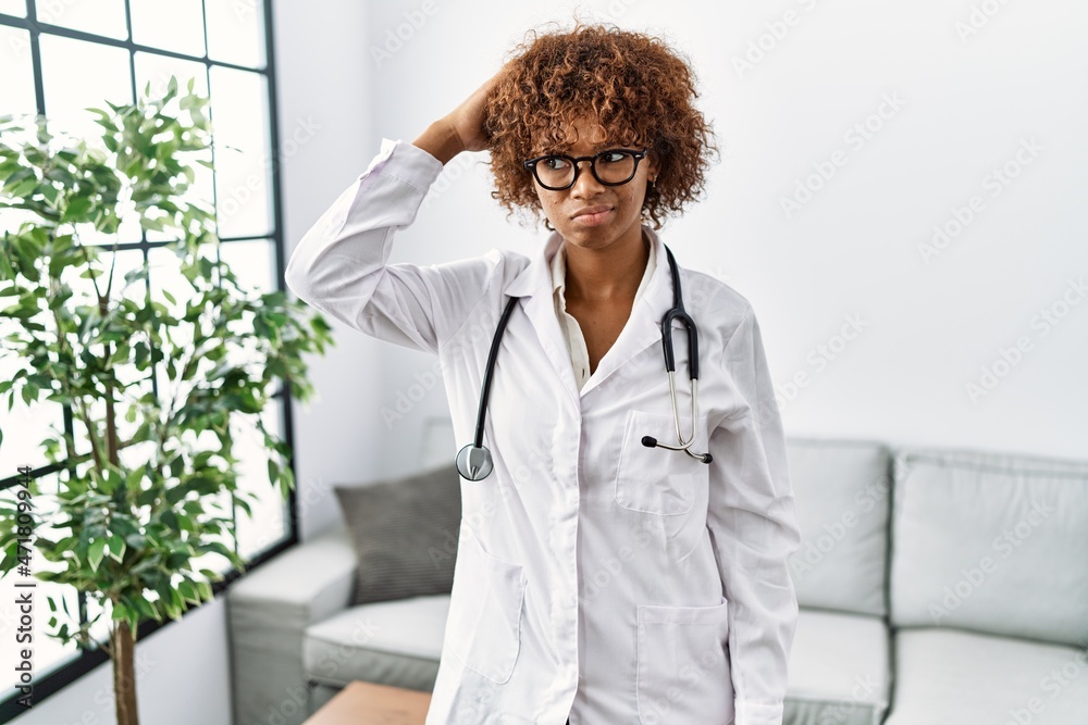 Young african american woman wearing doctor uniform and stethoscope ...