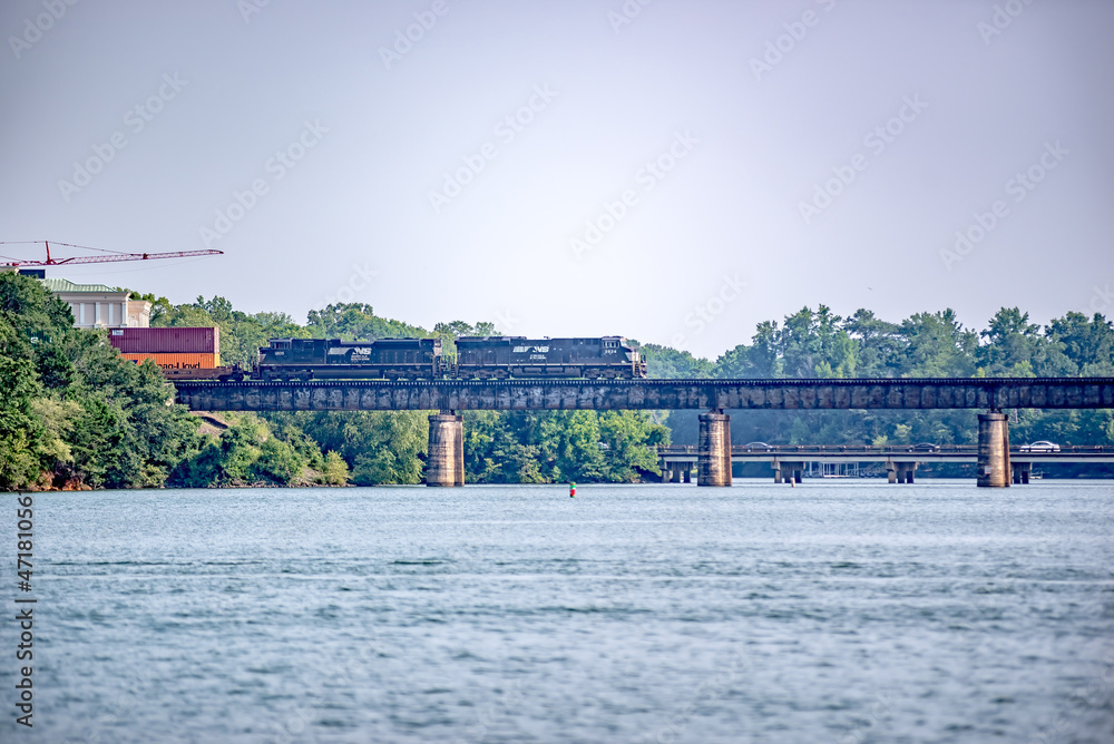 Fototapeta premium locomotive train bridge with train crossing lake