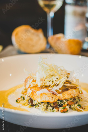 Sea bass roasted in curry butter, cauliflower,.pine nuts, coriander. © WeeYong