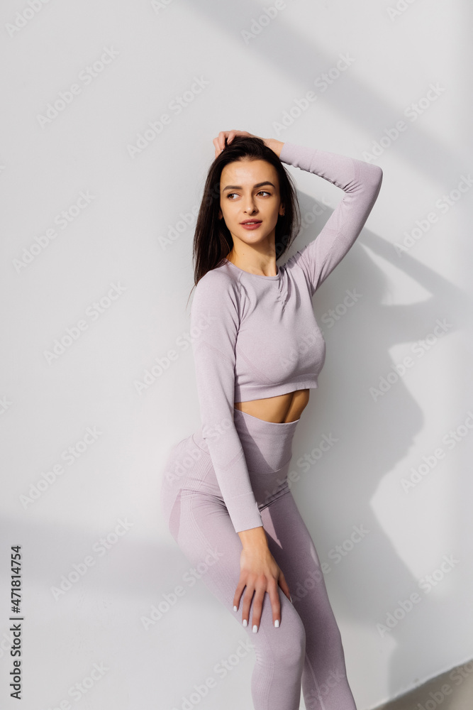 Young fitness woman stretching at home in the morning Young fitness woman stretching at home in the morning