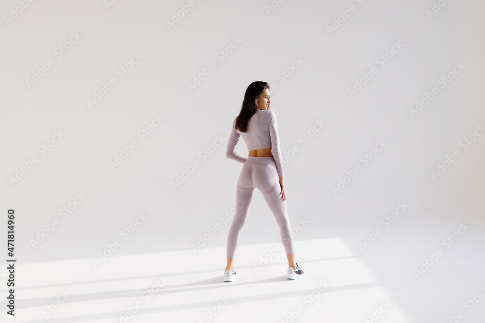 Full length portrait of a happy sports woman posing on a white background Full length portrait of a happy sports woman posing on a white background