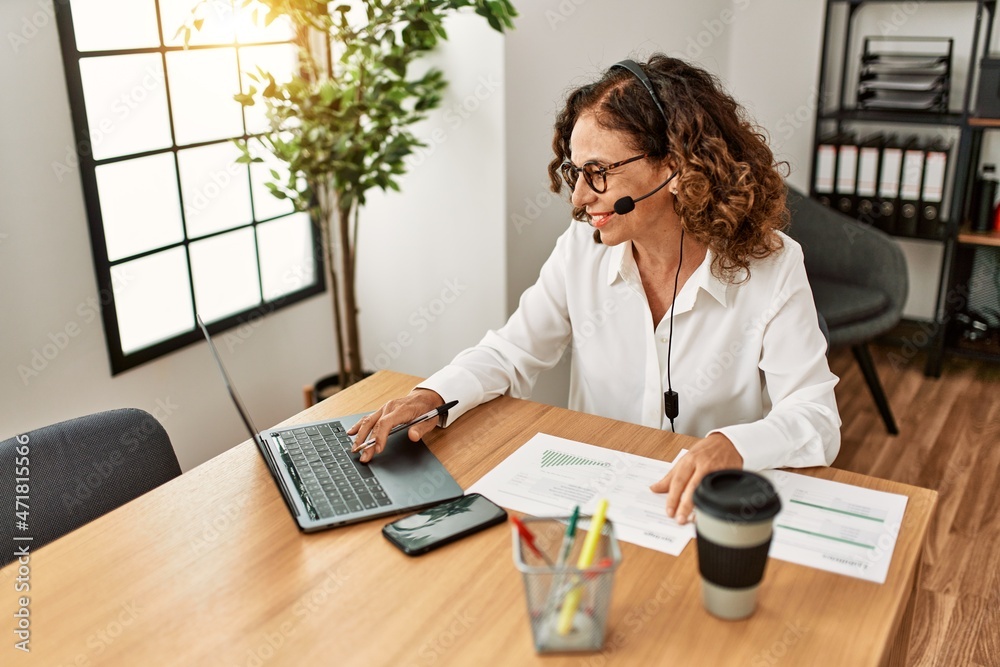 Middle age hispanic woman smiling confident working at office