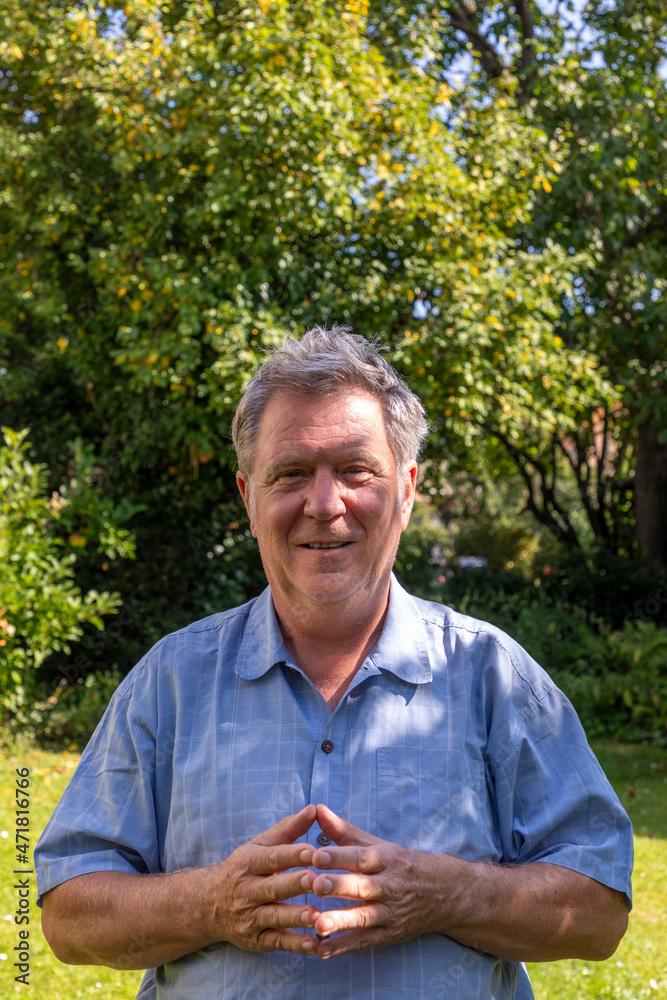 Fototapeta premium handsome senior man in the garden with positive smiling face