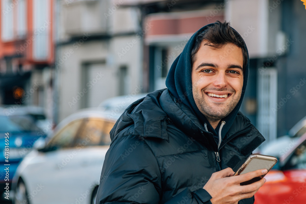 man in coat on the street with mobile phone man in coat on the street with mobile phone
