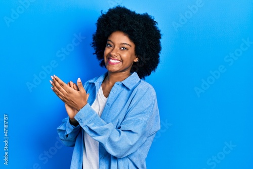 Young african american woman wearing casual clothes clapping and applauding happy and joyful, smiling proud hands together